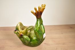 A 20th century green frog sculpture modelled laying on its back, h21cm