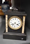 A late 19th century black slate mantel clock, having enable dial, Roman numerals and single bell