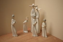A group of five Lladro and similar porcelain figures/figurines including 'Boy Kissing' model