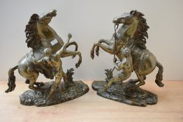 After Guilaume Couston (French 1677-1746) a pair of attractive reproduction cast patinated metal