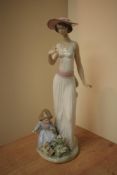 A Lladro porcelain figure group 'Flower in Bloom' model number 6648, measures 37cm tall, complete