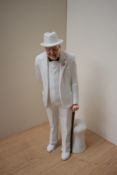 A Royal Doulton bone china figurine 'Sir Winston Churchill' HN 3057, measures 26cm tall.