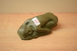 A carved stone sleeping nude, in dark green, bearing signature 'MM' to back.