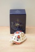 A Royal Crown Derby bone china Turtle paperweight, having Imari style decoration and a gold coloured