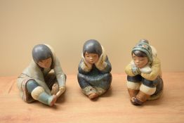 A group of three Lladro porcelain Eskimos figures comprising 'Cold Feet' model number 2157, 'Pensive