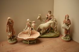 A group of four continental porcelain figures ,in the manner of Royal Dux, depicting various