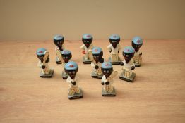 A group of ten vintage Robertson Jam figures all depicted as cricketers.