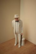 A Royal Doulton bone china figurine 'Sir Winston Churchill' HN 3057, measures 26cm tall.