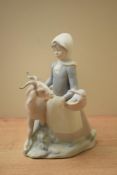 A Lladro porcelain figure group 'Girl with Goat' model number 4812, in matt finish measuring 22cm.