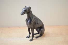 A 19th/20th century heavy cast and patinated bronze seated greyhound study, modelled seated with