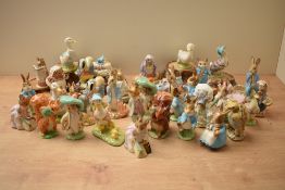 A large assortment of Royal Albert Bone china and Beswick Pottery Beatrix Potter character studies