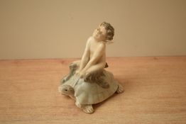 A Royal Copenhagen porcelain figure group 'Faun riding on Tortoise' model number 858, measures 9cm.