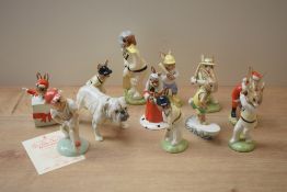 A group of nine Royal Doulton bone china Bunnykins characters including 'Aussie Surfer Bunnykins'