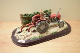A Leonardo Collection model tractor study on wooden plinth, damage to tractor, having signature to