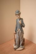 A Lladro porcelain figure 'Charlie Chaplin' model number 5233, measures 28cm tall.