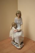A Lladro porcelain figure group 'Bedtime Story' model number 5457, measures 26cm tall, complete with