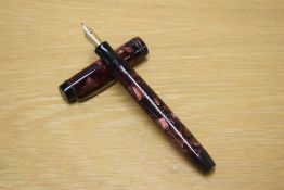 A Parker Duofold button fill fountain pen in Burgundy and Rose marble with two narrow cap bands