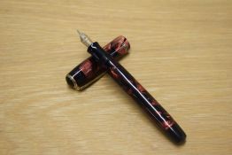 A Parker Duofold Callenger Standard button fill fountain pen in Red and Black marble with three