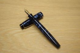 A Parker Duofold button fill fountain pen in Blue and Black marble with a narrow cap bands having