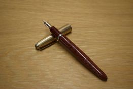 A Parker VP button fill fountain pen in Rust with a Rolled Gold cap having a Parker USA nib