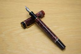 A Parker Duofold International converter fill fountain pen in Maroon Marble with three pearl cap