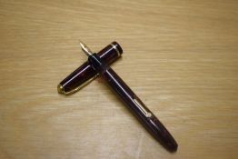 A Conway Stewart Dinkie 560 lever fill fountain pen in Maroon and Gold Marble with a single cap band