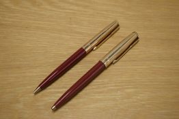 A Parker 61 ballpoint pen and propelling pencil in Rage Red with Rolled Gold cap