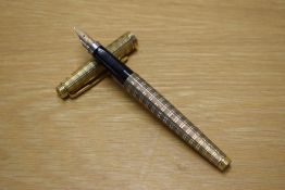A Parker 75 converter fill fountain pen in Gold plated Ecosse pattern having Parker 14K USA nib