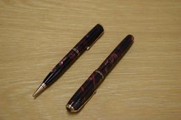A Parker Duofold Junior button fill fountain pen and Propelling pencil in Burgundy and Black