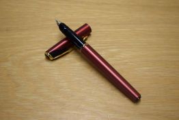 A Parker Inflection converter fill fountain pen in Sunny Red