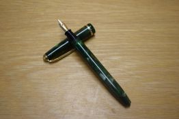 A Conway Stewart Dinkie 560 lever fill fountain pen in Green and Brown Marble with a single cap band