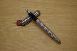 A Parker Sonnet converter fill fountain pen in Silver Plated Chiselled Tartan pattern with gold trim
