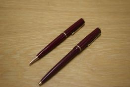A Parker Duofold Ballpoint pen and Propelling Pencil in Burgundy with single narrow decorative band