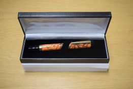 A boxed Sigma converter fill fountain pen in Orange Swirl having Iridium Point Germany nib