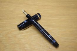 A Parker Duofold button fill fountain pen in Blue and Black marble with a wide cap bands having a