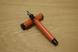 A Parker Duofold Junior Lucky Curve button fill Big Red fountain pen with single wide cap band