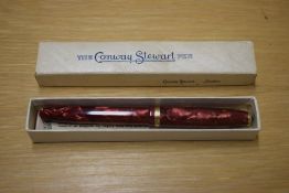 A boxed Conway Stewart 85L lever fill fountain pen in Rose Pink with Gold veining having single