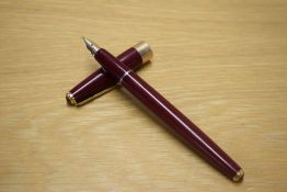 A Parker 17 aerometric fountain pen in Burgundy having board band to the cap having 14K Parker