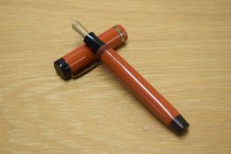 A Parker Duofold Senior button fill fountain pen in Big Red with single wide cap band having