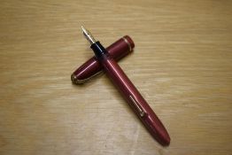 A Conway Stewart Dinkie 560 lever fill fountain pen in Rose Pink with a single cap band having