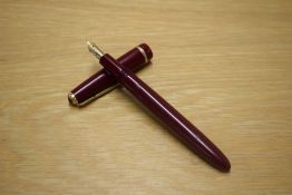 A Parker Slimfold aerometric fill fountain pen in Burgundy with decorative cap band having Parker