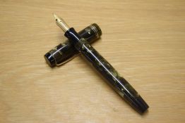 A Parker Duofold button fill fountain pen in Green and Pearl with one wide and two narrow cap