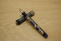 A Parker Lady Duofold Lucky Curve button fill fountain pen in Black and Pearl with three narrow
