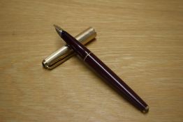 A Parker 65 aerometric fill fountain pen in Maroon with a gold cap
