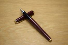A Parker 75 converter fill fountain pen in Laque Maroon with Gold trim having Parker 14K USA nib