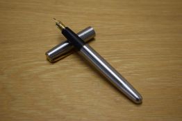 A Parker Frontier cartridge fill fountain pen in Flighter stainless steel with gold trim having