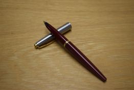 A Parker 45 cartridge converter fill fountain pen in Red with steel cap with gold trim