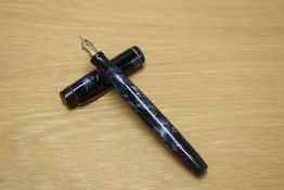 A Parker Duofold button fill fountain pen in Blue and Black marble with a narrow cap bands having