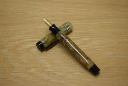 A Parker Duofold button fill fountain pen in Green and Pearl with three cap bands having Parker