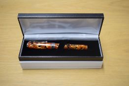 A boxed Sigma converter fill fountain pen in Red, Black and Yellow Marble having Iridium Point